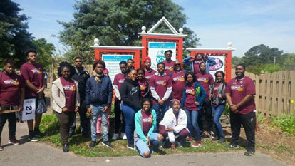 AAMU student volunteers in maroon and white T-shirts