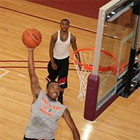 An intramural basketball player attempts a lay-up at the Wellness Center basketball gym