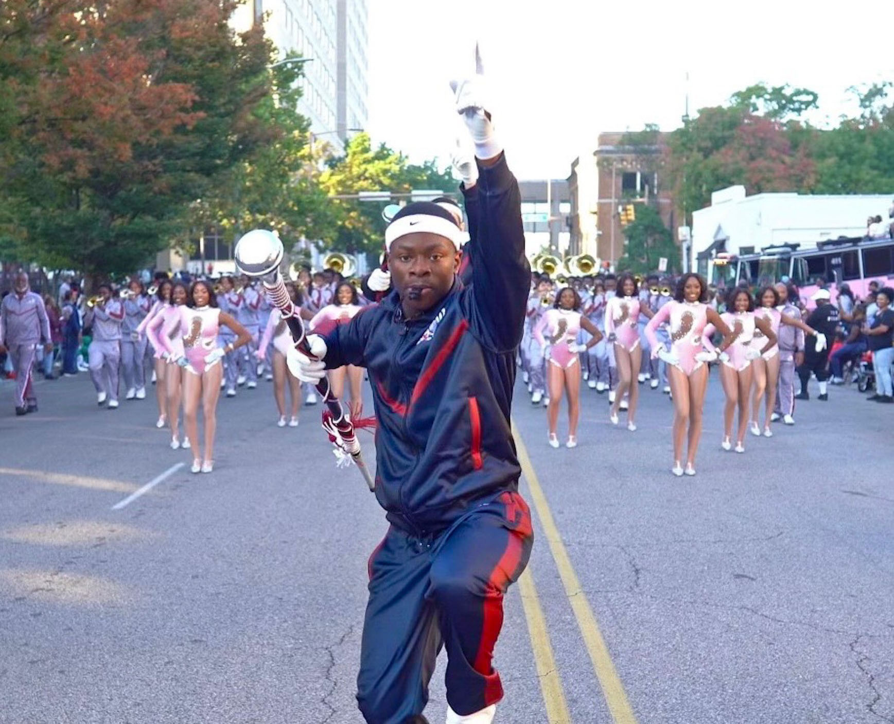 AAMU Head Drum Major holds whistle in mouth and carries his mace as he high steps and leads the MMW as the 2024 Magic City Classic Parade