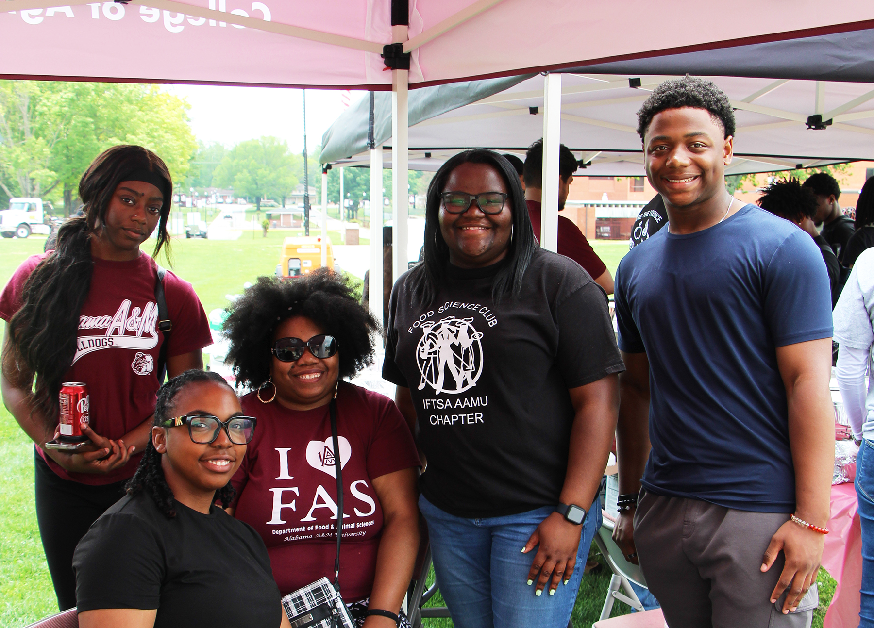 Five Alabama A&M University students under tent at 2025 Ag Day.