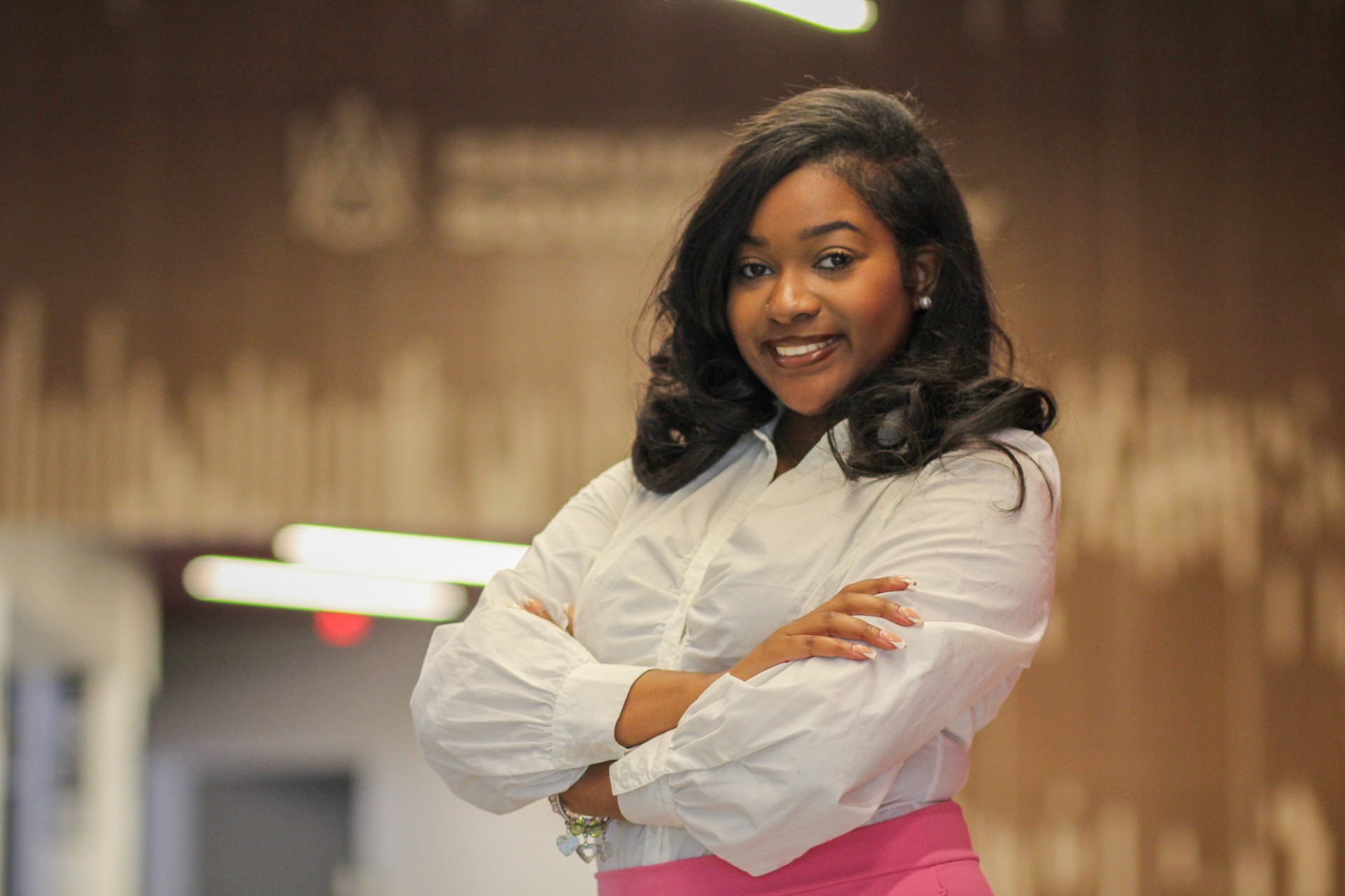 Graduating senior Alyvia Mallard smiles while standing on second floor of AAMU Event Center 