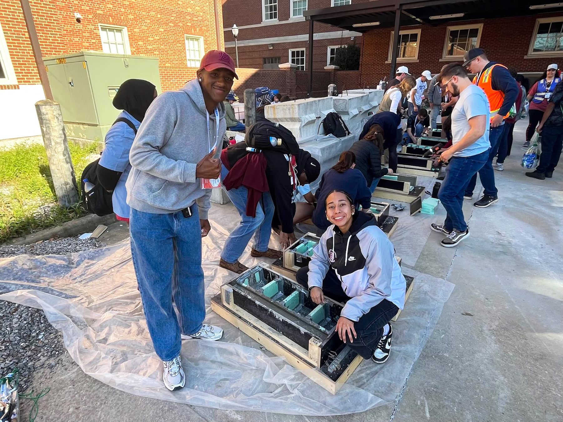 Male and female AAMU students working on outdoor project at ASCE Gulf Coast Symposium
