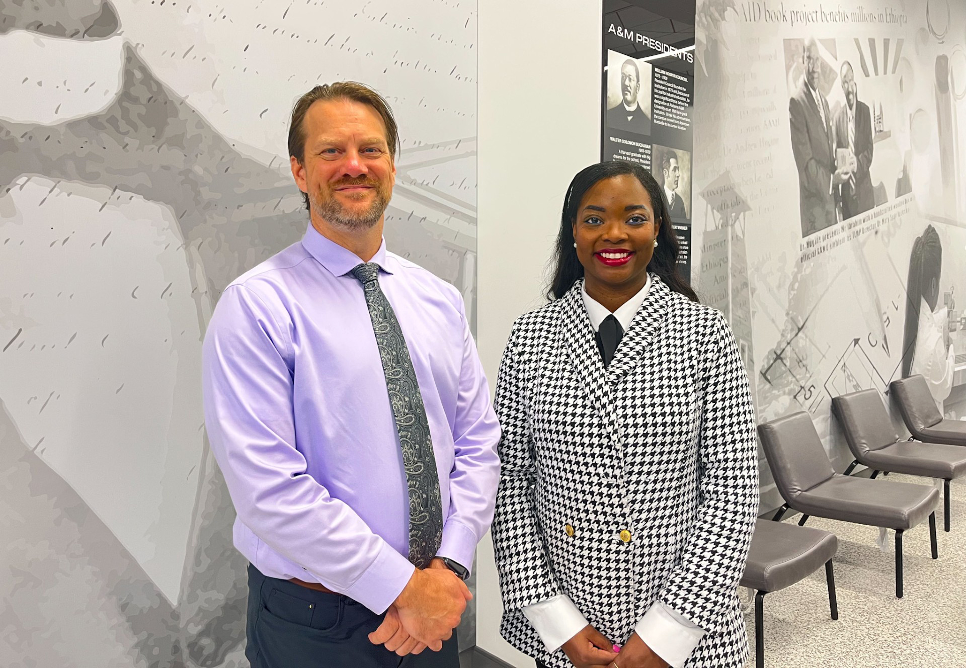 Dr. Nathan Blom and Dr. Samantha Strachan stand and smile in AAMU Event Center Lounge