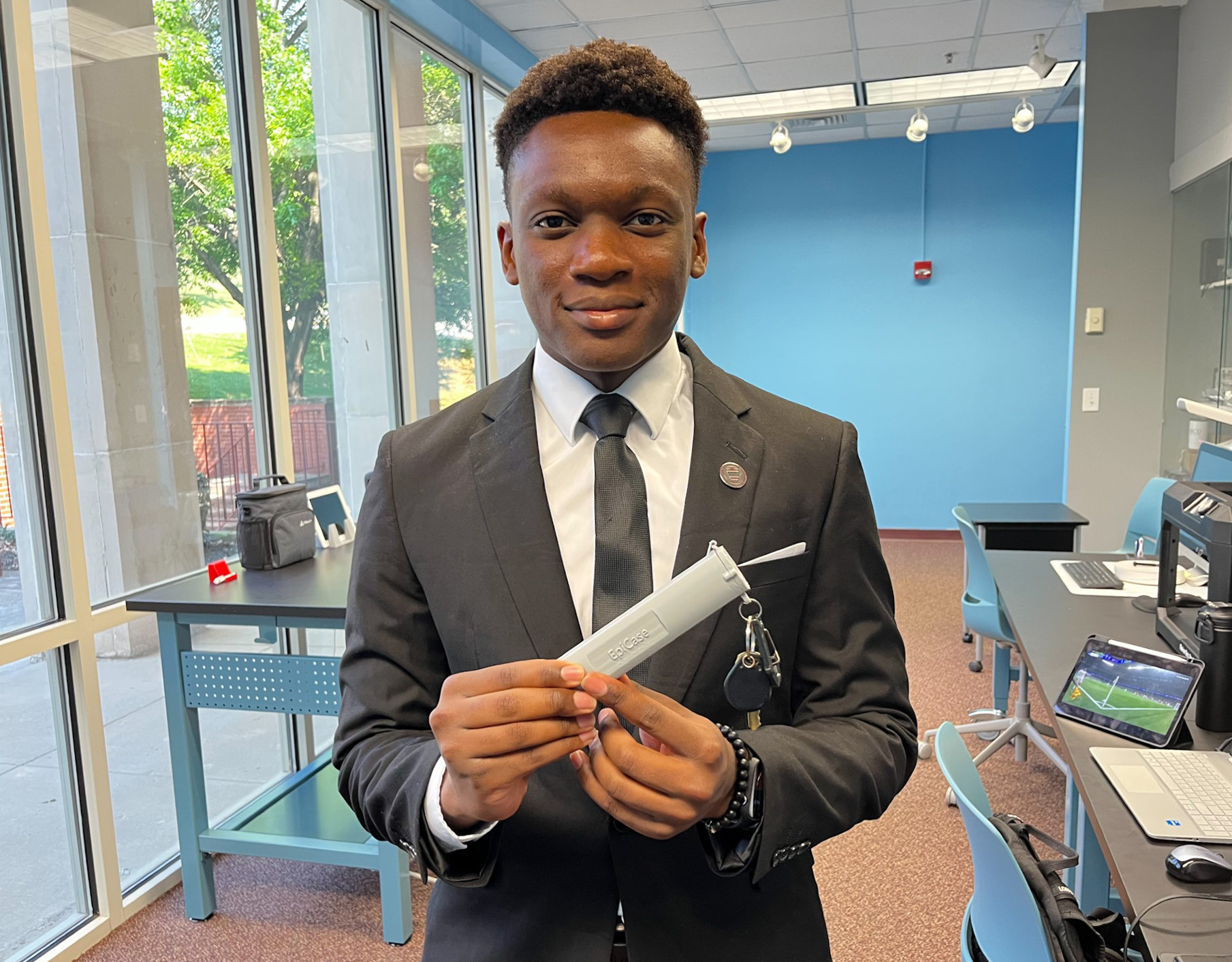 Bukata Mubanga in the AAMU Makerspace Lab holding the EpiPen case he created