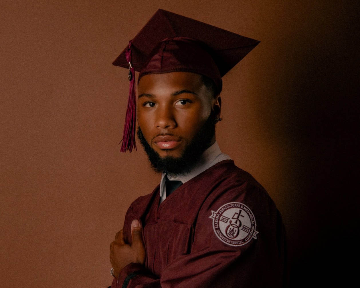 Keishon Bostic wearing special AAMU 150th Anniversary graduation gown