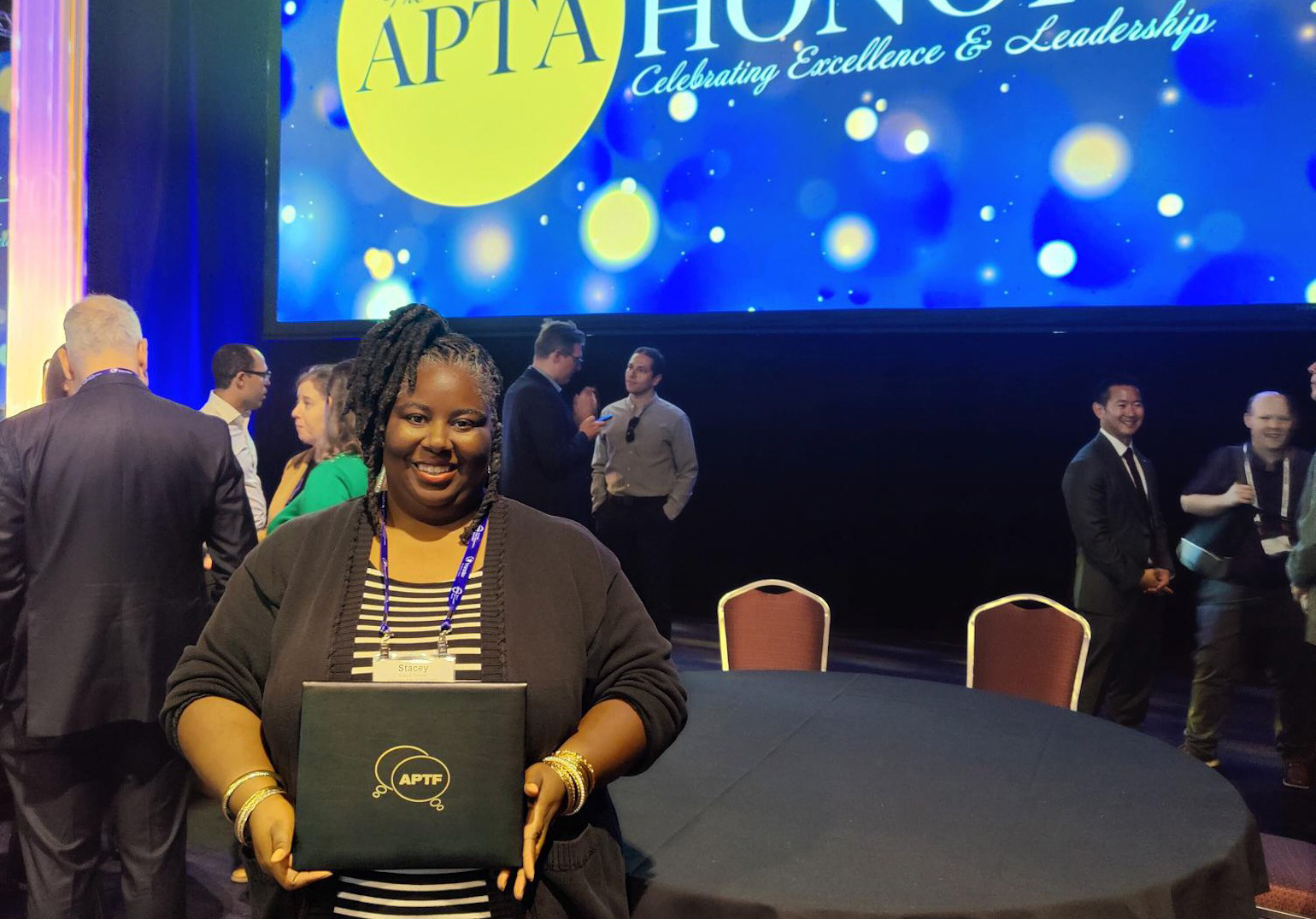 Stacey Brewer holds scholarship certificate after she was recognized at the APTA Annual Meeting in Boston