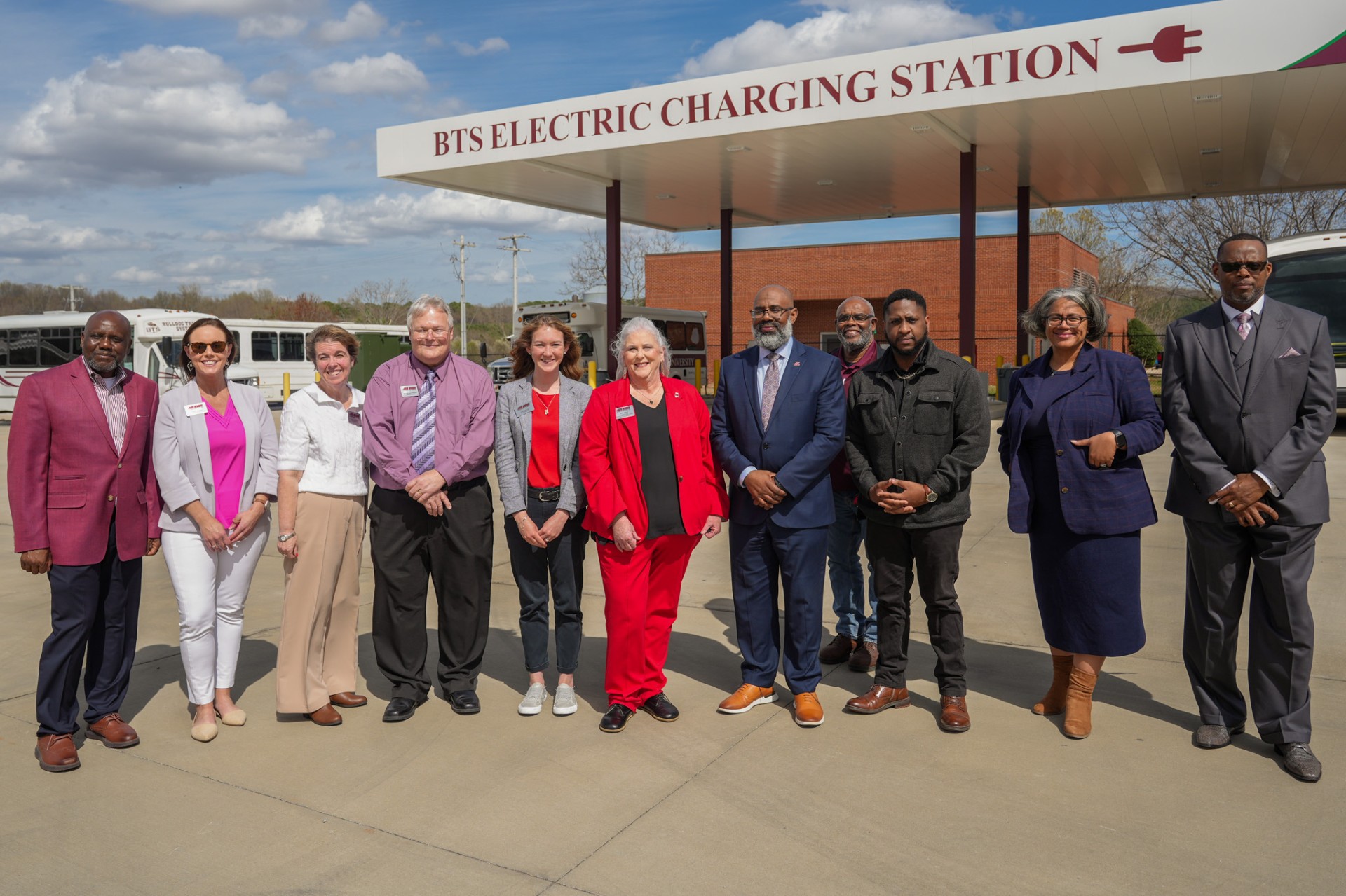 AAMU BTS and Jax State Administrators stand in front of AAMU Electric Bus Charging Station