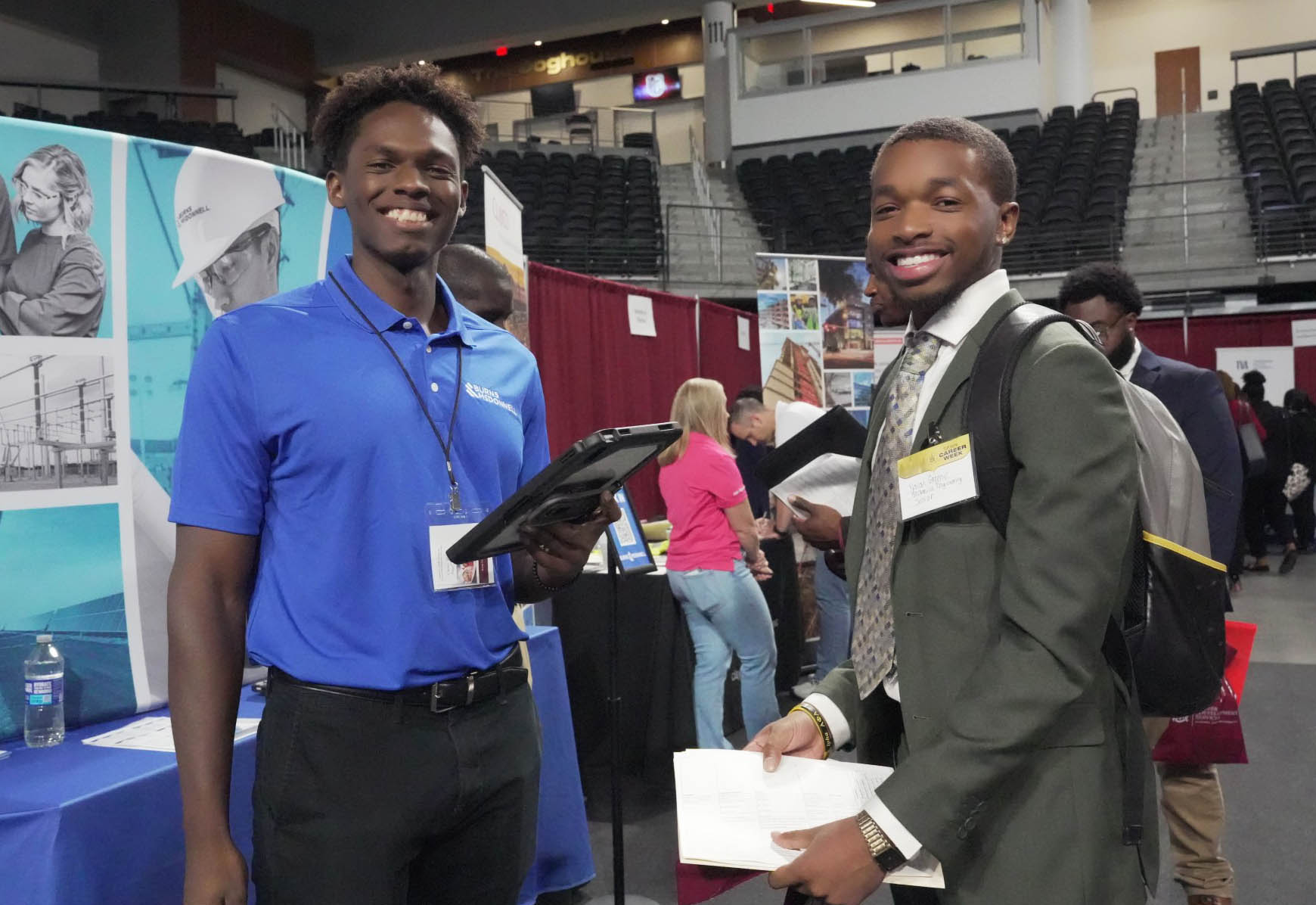 Two male students attending AAMU's Fall 2024 Career Fair smile at camera