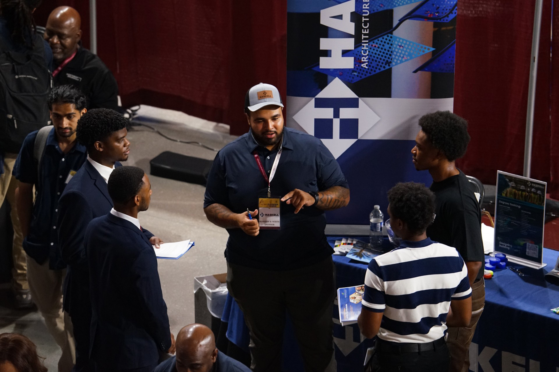 Employer talks as four students listen during the Fall 2025 Career Fair at the AAMU Event Center 