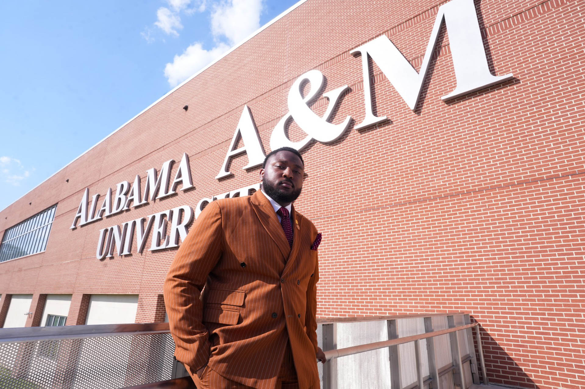 Christian Emonina with AAMU Event Center behind him