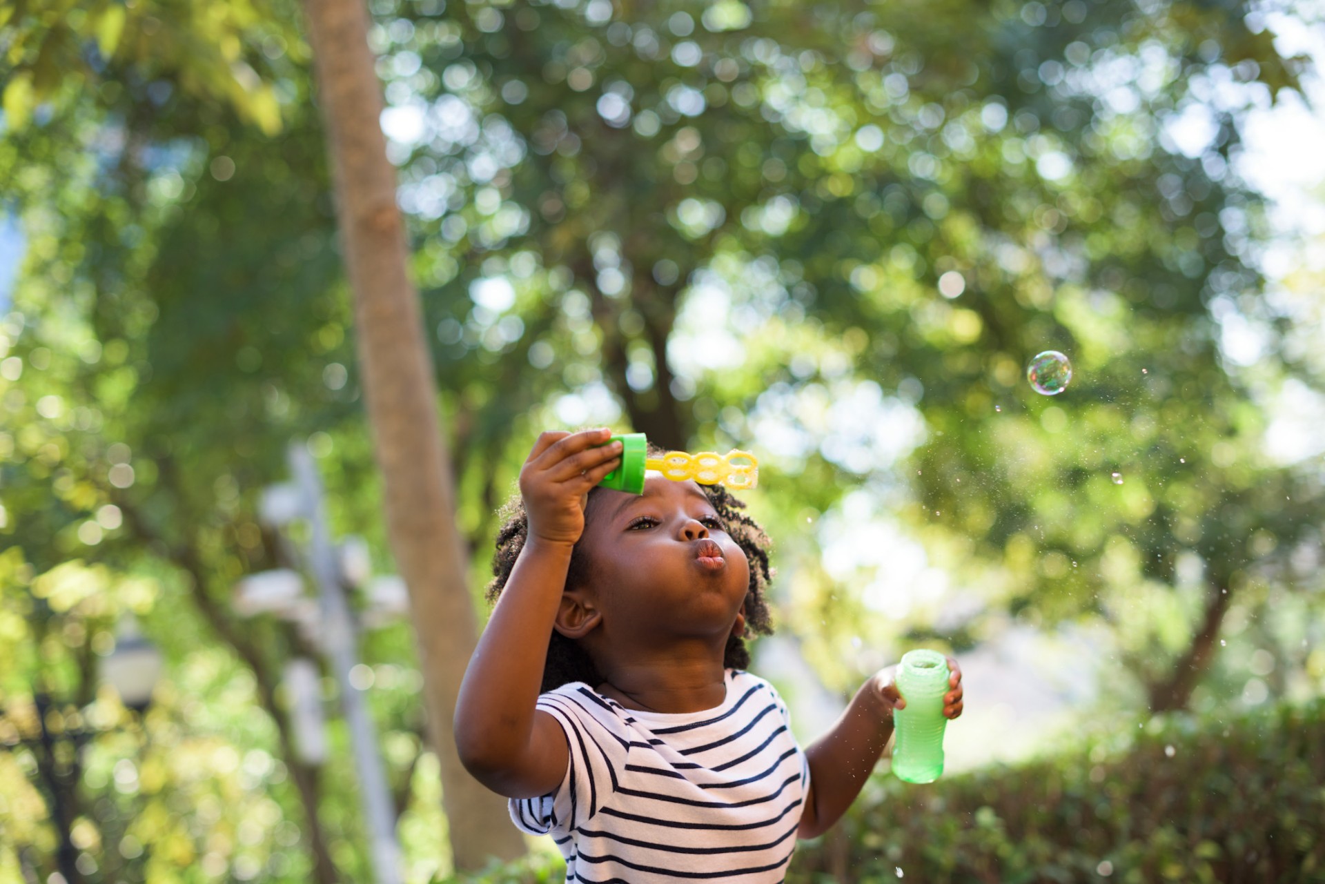 Little girl blowing bubbles