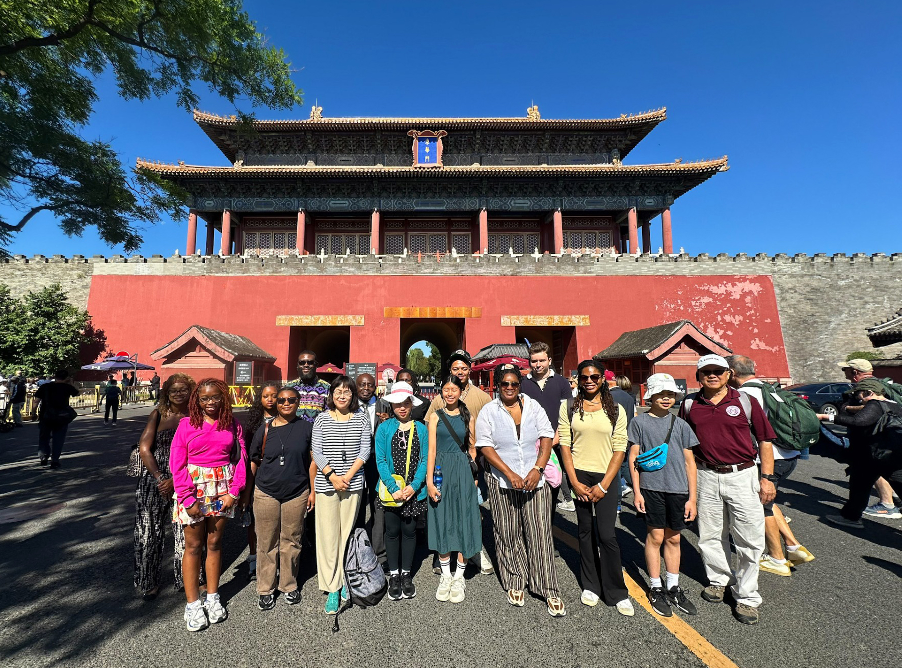 Students and staff pose at Donghua Gate, the eastern entrance to the Forbidden City, in Beijing.