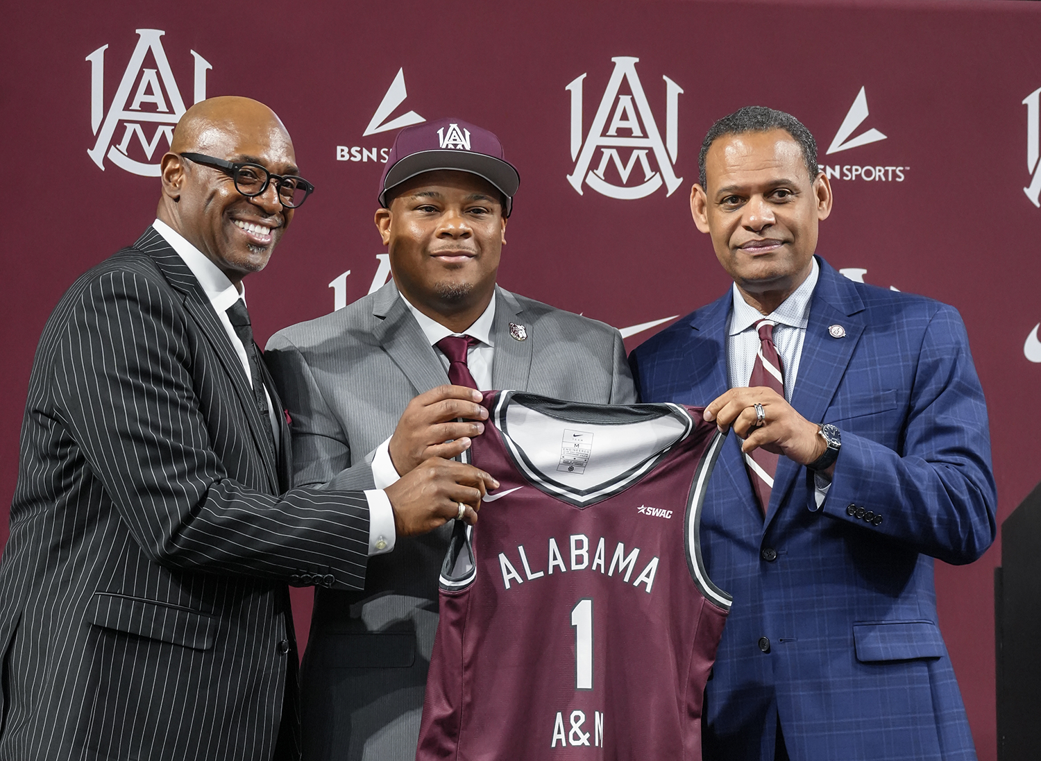 Dr. Paul Bryant, New Head Coach Dante' Jackson and President Daniel K. Wims hold Bulldog Jersey at news conference