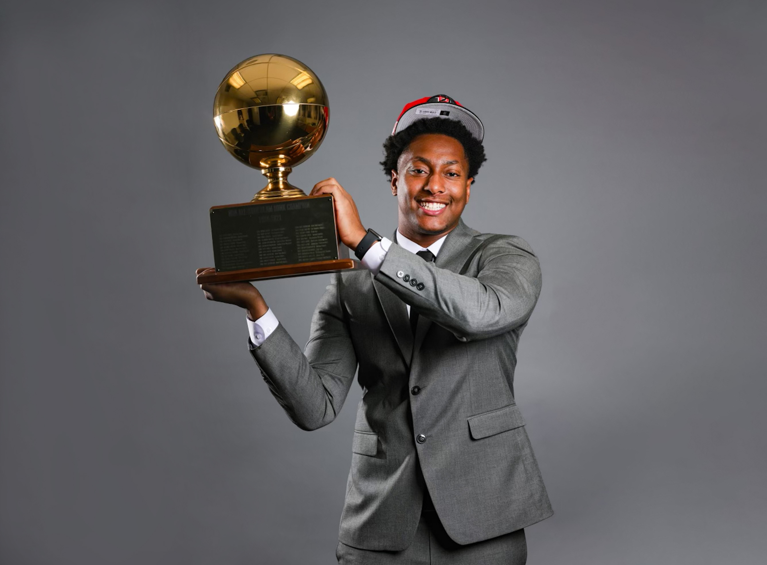 Collin Malone holds Slam Dunk Contest trophy during his internship with the Houston Rockets