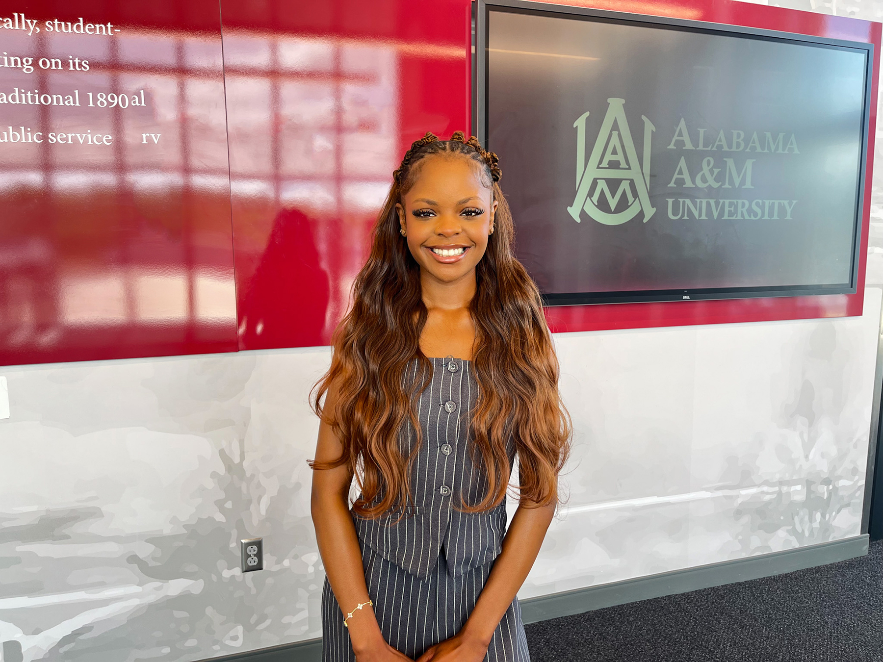 Cailyn Cooks smiles in the entrance to the AAMU Event Center
