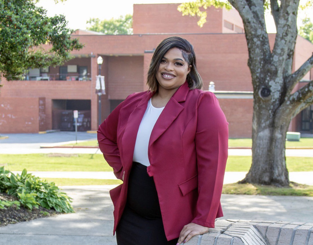 Diamond Gooden smiles as she stands near the New School of Business of the AAMU campus