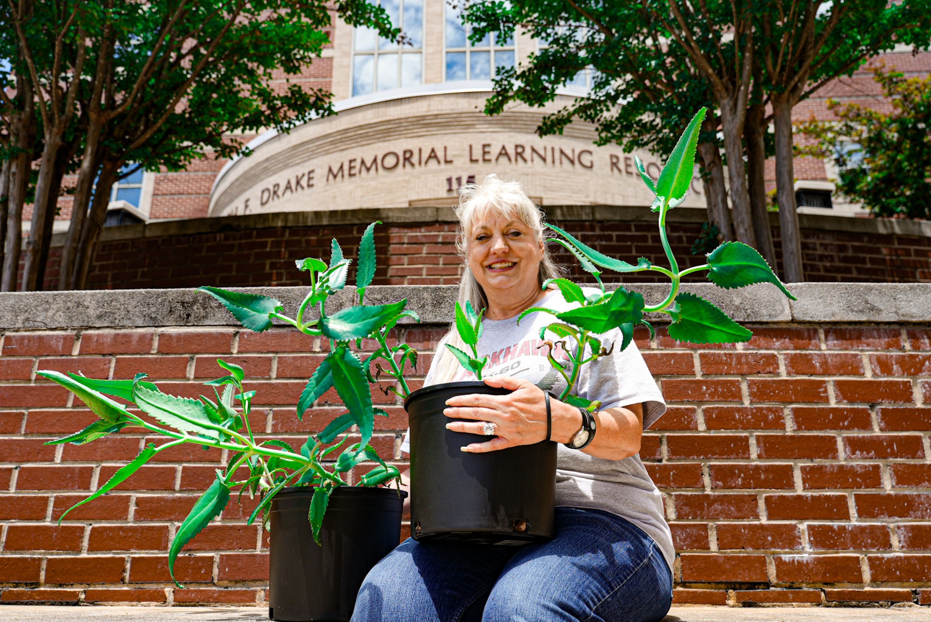 Donica Richmond and her plants in front of the AAMU Library