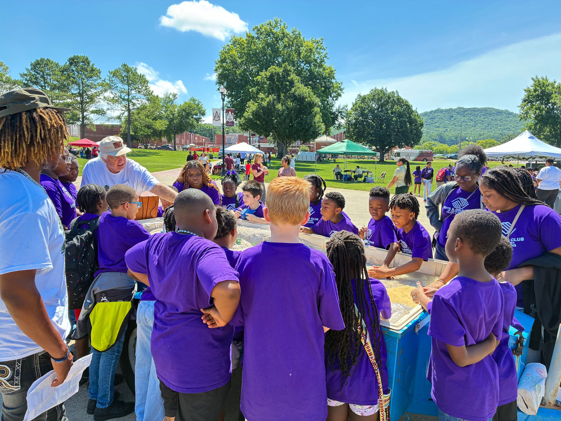 Students gather around Dr. William Stone's demonstration of watershed and conservation at Forestry Fair.