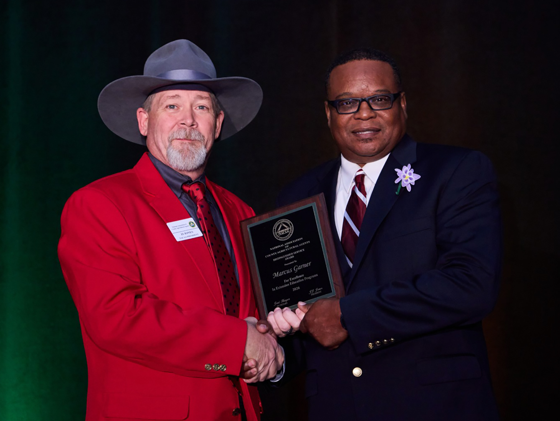 National NACAA President JJ Jones congratulates Marcus Garner on receiving the Distinguished Service Award. 
