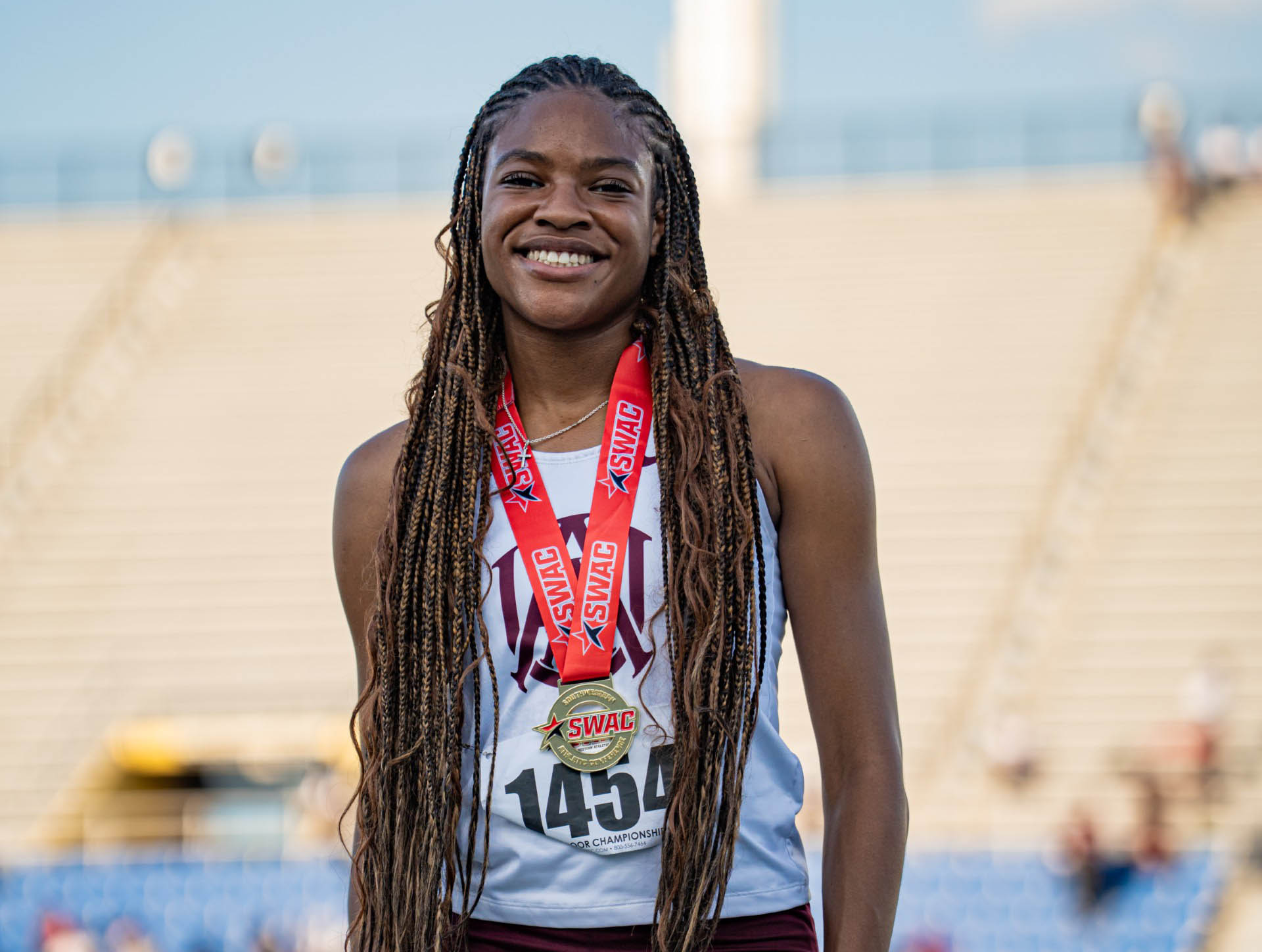 Laila Gaynor smiles while wearing SWAC medal