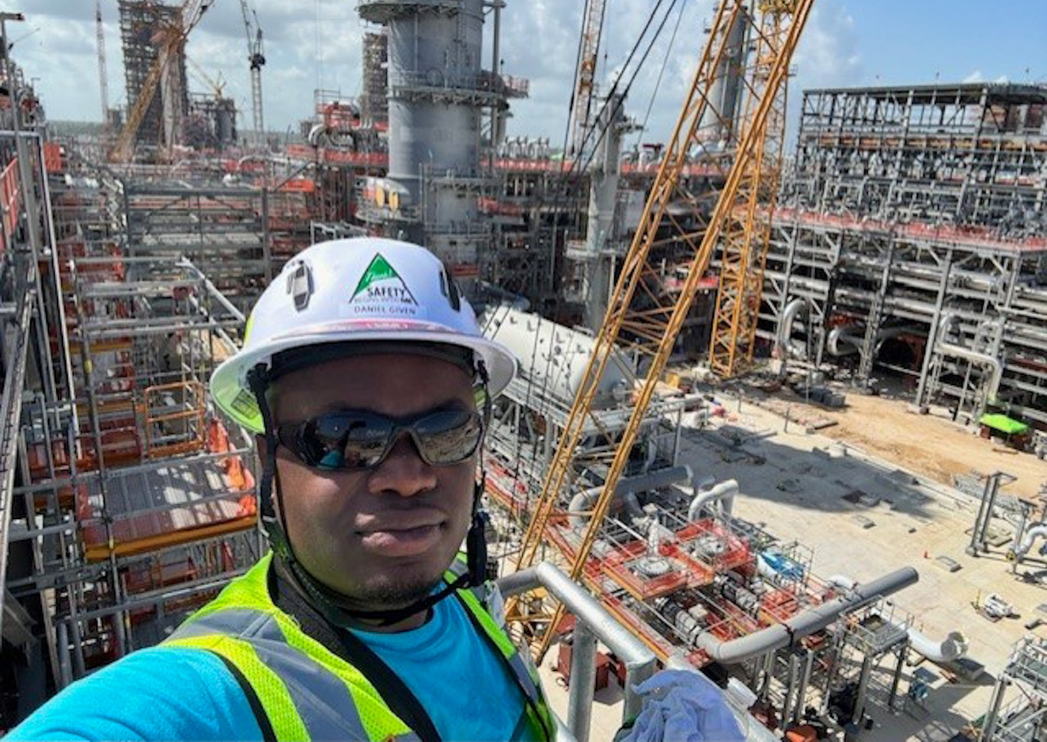 AAMU Senior Daniel Given Jr. standing atop scaffold at construction site for the Golden Triangle Polymer Plant in Texas