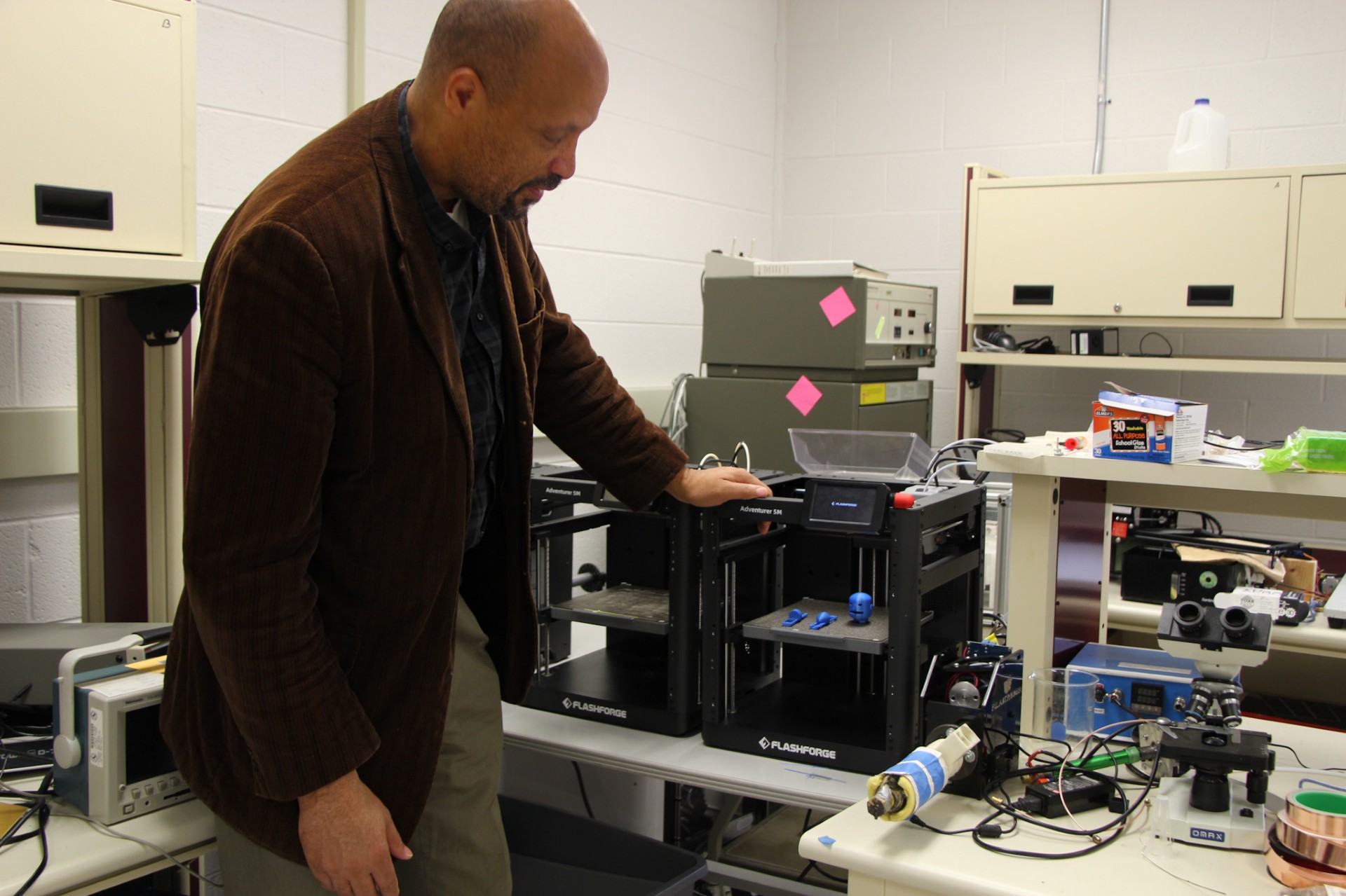 Glenn looking at 3-D printing of AppBot head and feet