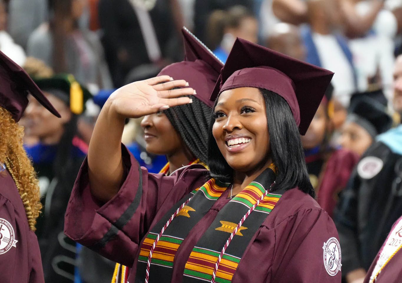 Student waves at AAMU Spring 2025 Commencement