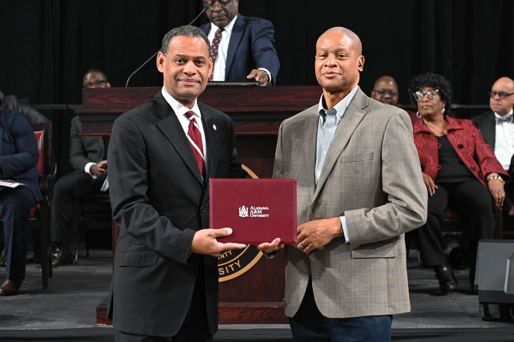 AAMU President Dr. Daniel Ki Wims and Director of Undergraduate Admissions, Mr. Dwyane Green hold certificate recognizing Green's work during the 2025-2026 academic year
