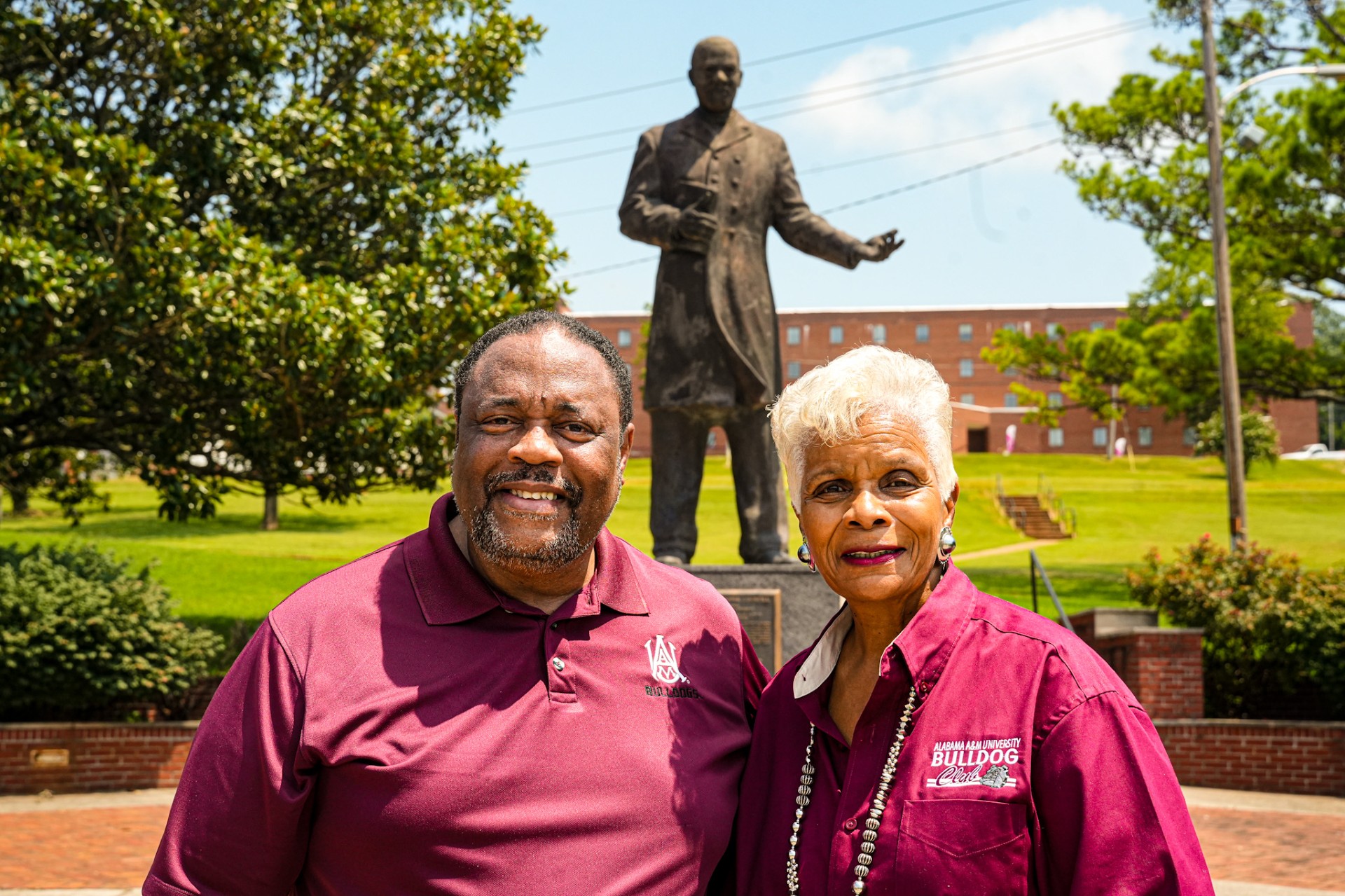 Jerome Saintjones and Georgia Valrie stand in front of statue at William Hooper Councill Memorial Plaza