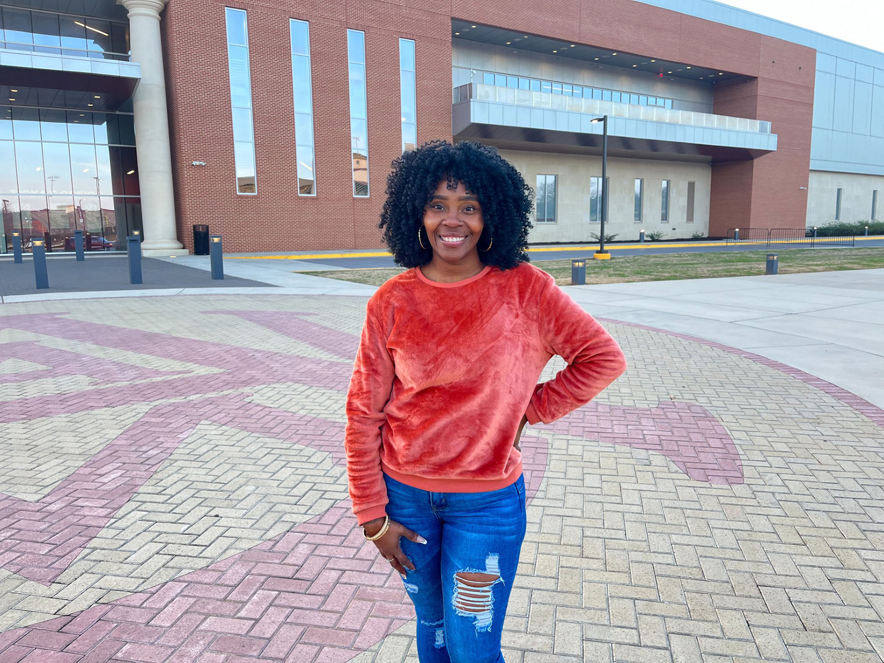 Jalisa Williams smiling in front of AAMU Event Center