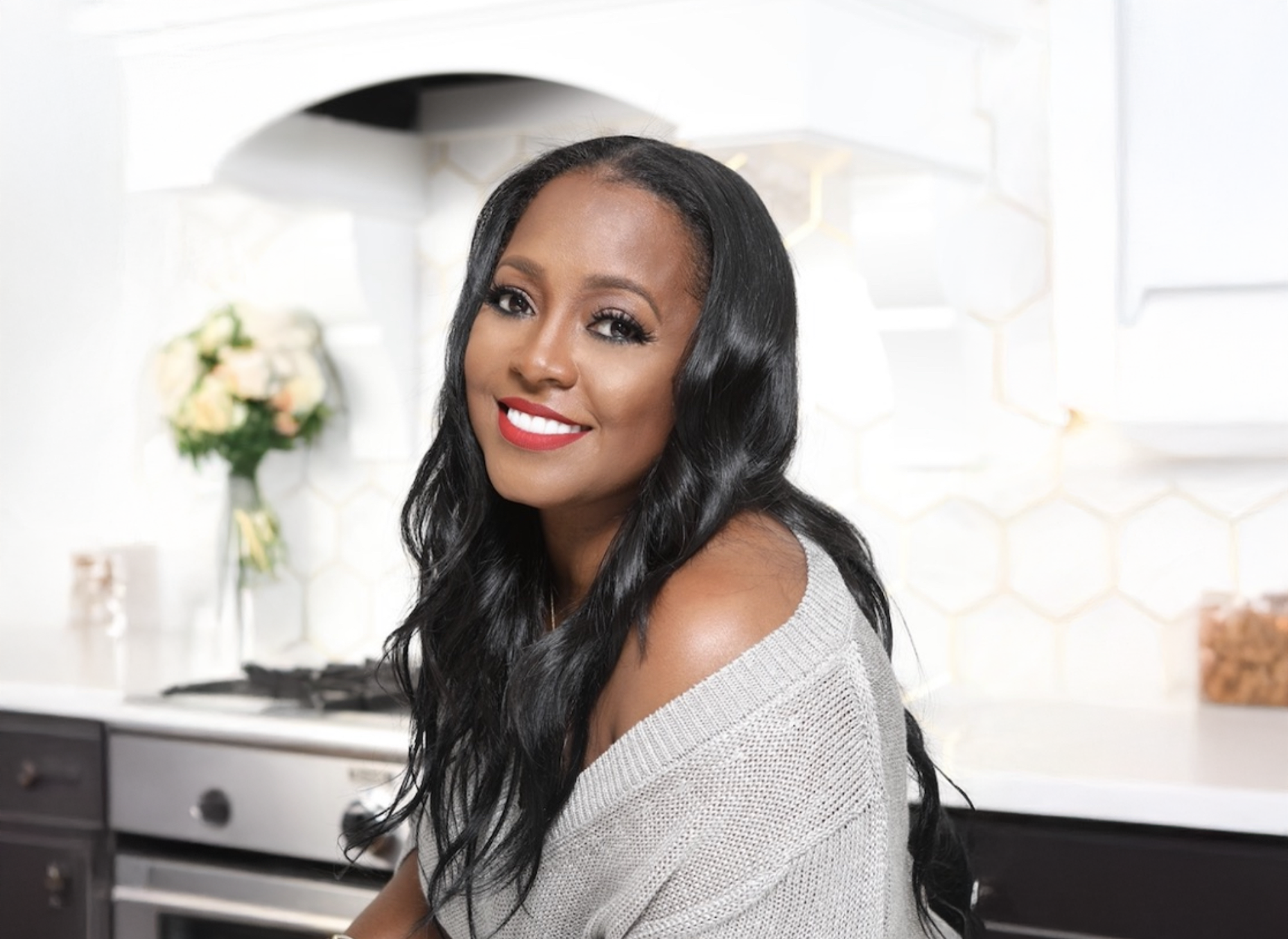 Keshia Knight Pulliam with white kitchen in the background