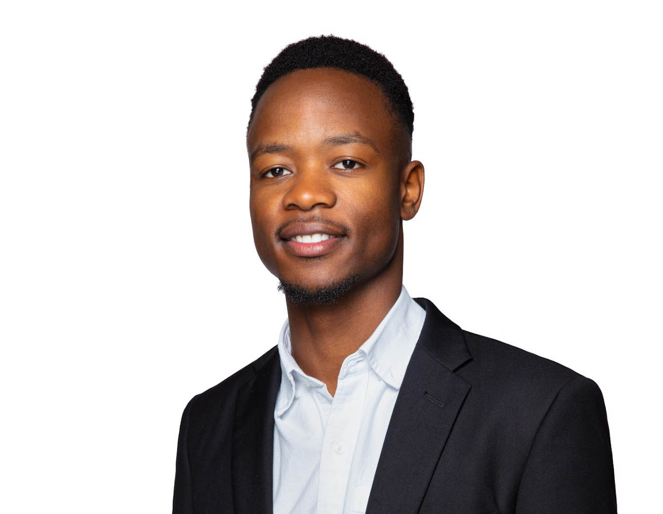 Goodwill Munashe Kwenda smiling with black business jacket with white background