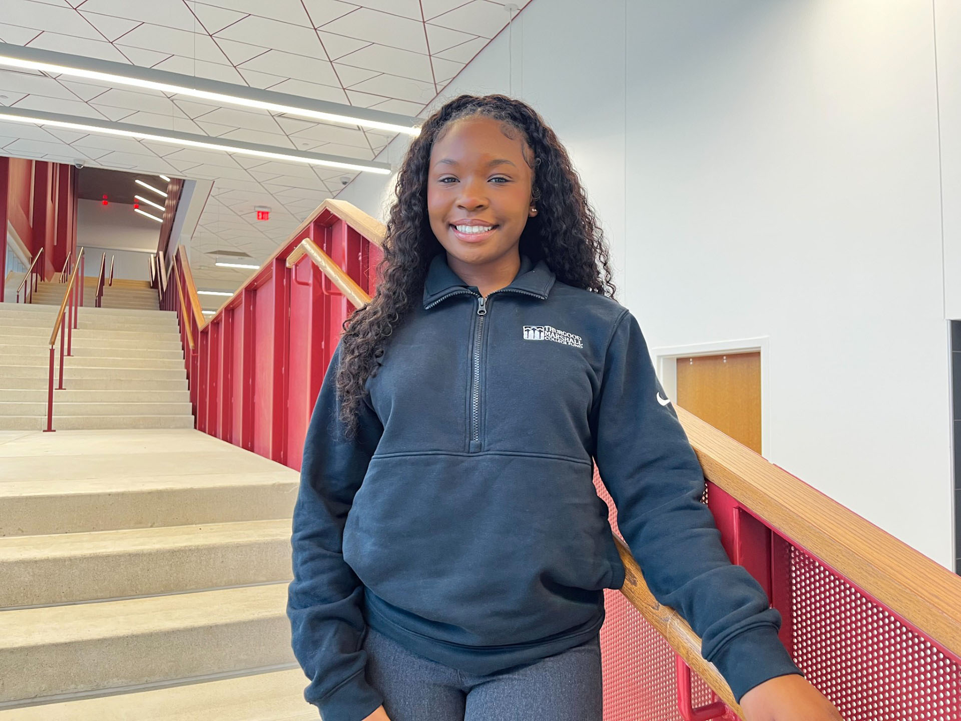 Limyra Tucker smiles on the steps of the AAMU Event Center