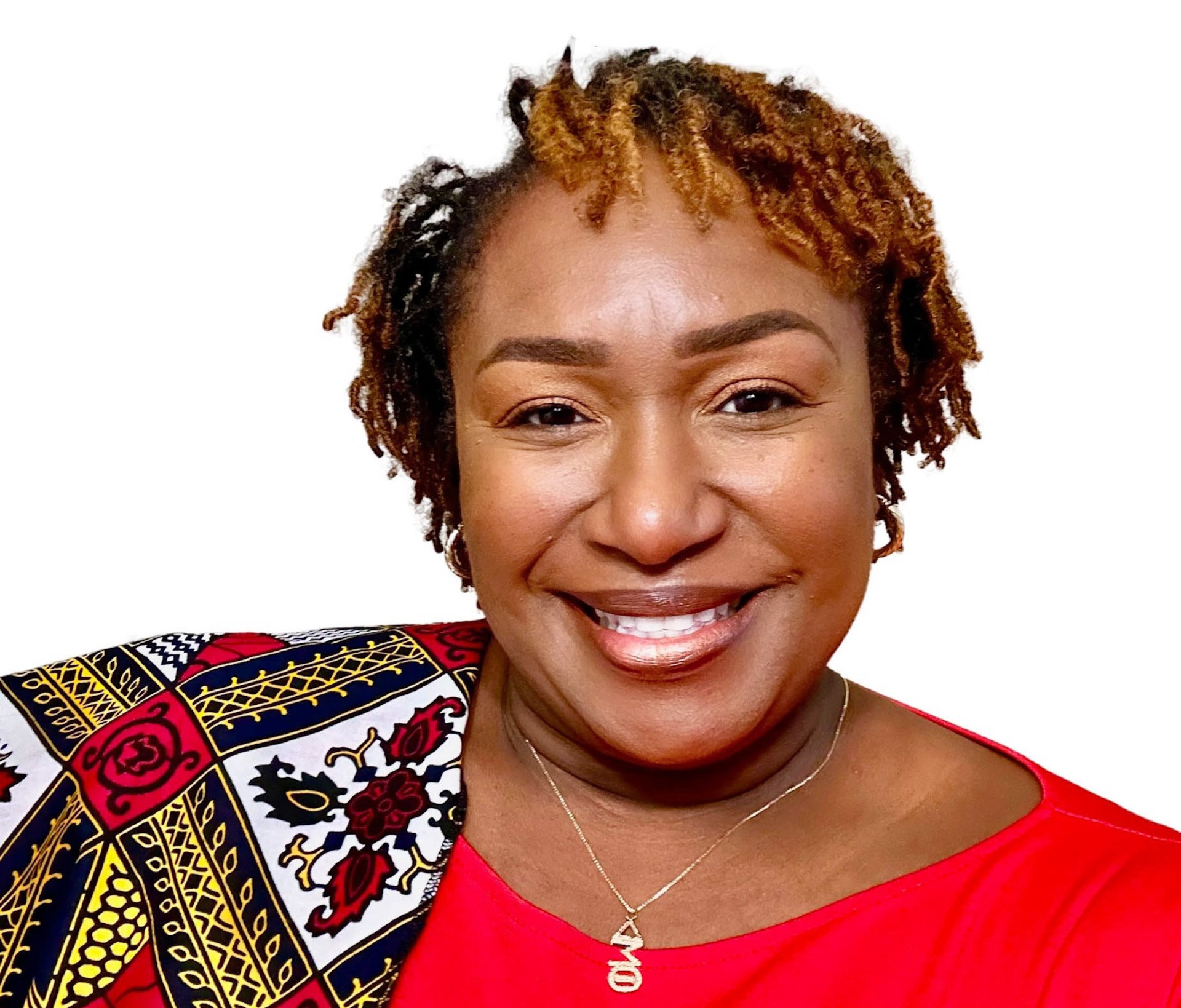 AAMU Ph.D. student Christina Lincoln-Moore wears crimson top with printed scarf and Delta Sigma Theta Sorority, Inc. necklace and smiles at camera
