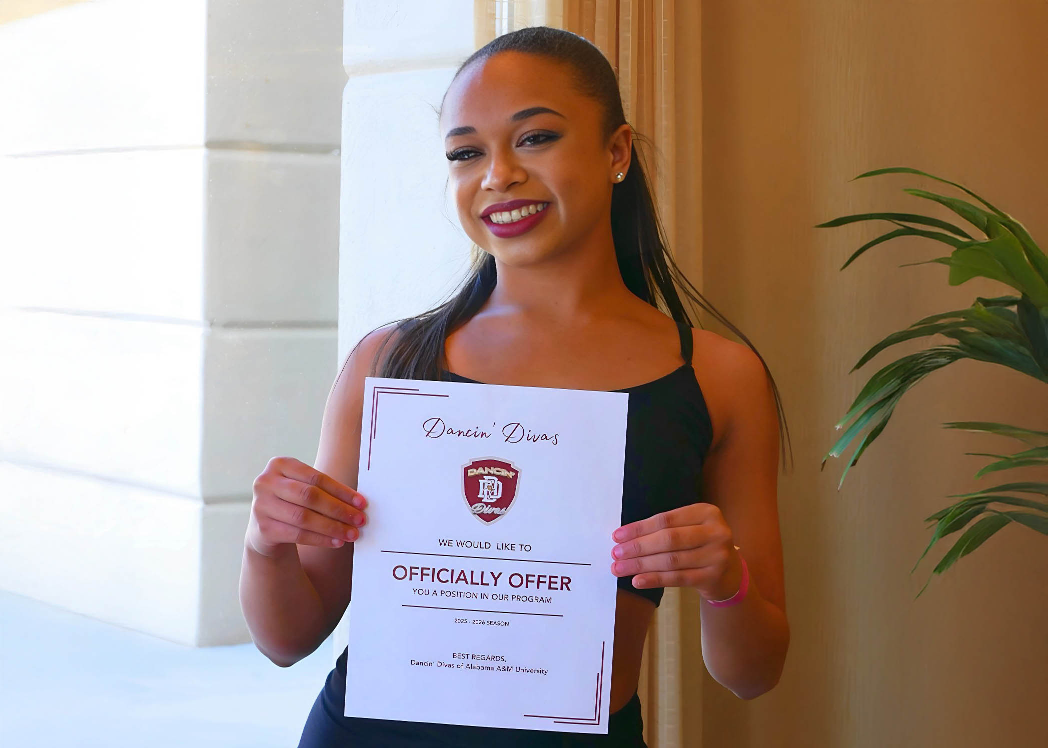 Londyn Phillips holds letter offering her a position with the AAMU Dancin' Divas