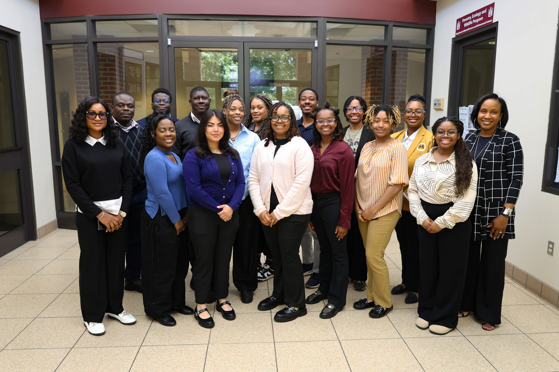 Students Chidinma Njoku, Karyn Rose, Maria Martinez, Alexis-Marie Parrish, Taylor-Nicole Tate, Lauryn Strong, Faith Wamble and Armitra Jackson-Davis. Back row, from left, are Emmanuel Oko, Philip Bwalya, Stephane Jean Noel, Charquenta Dishmon, PkeRaven Turner, Kaleb Jackson, Emille White and Ruth Fennell pose for a group photo at the entrance of the ARC Building on campus