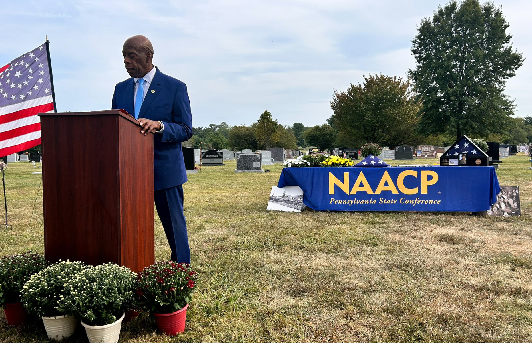 AAMU alumnus and retired U.S. Navy Rear Admiral Clyde Marsh speaks at podium at ceremony honoring Evelyn C. (Preston) LeSueuer and giving her a military marked grave 