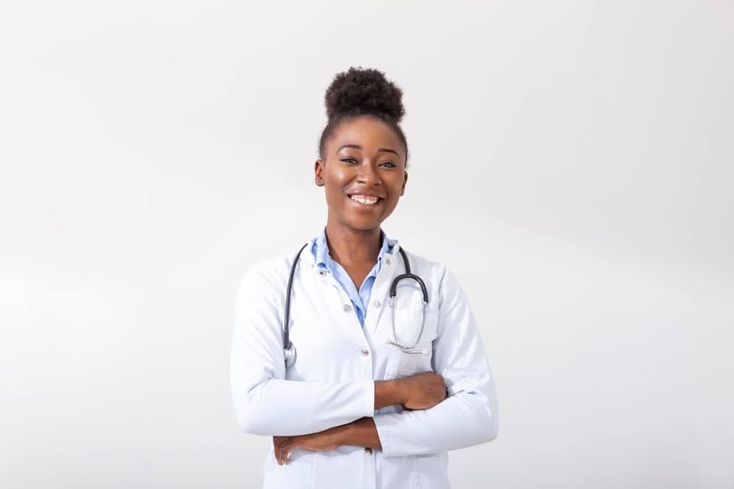 Smiling student wearing white physician's jacket
