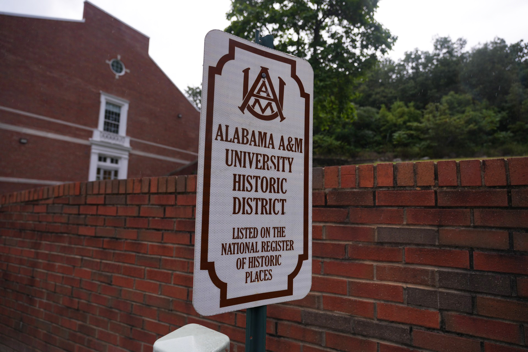 Sign stating Alabama A&M University Historic District: Listed on the National Register of Historic Places near the Bell Tower on The Block