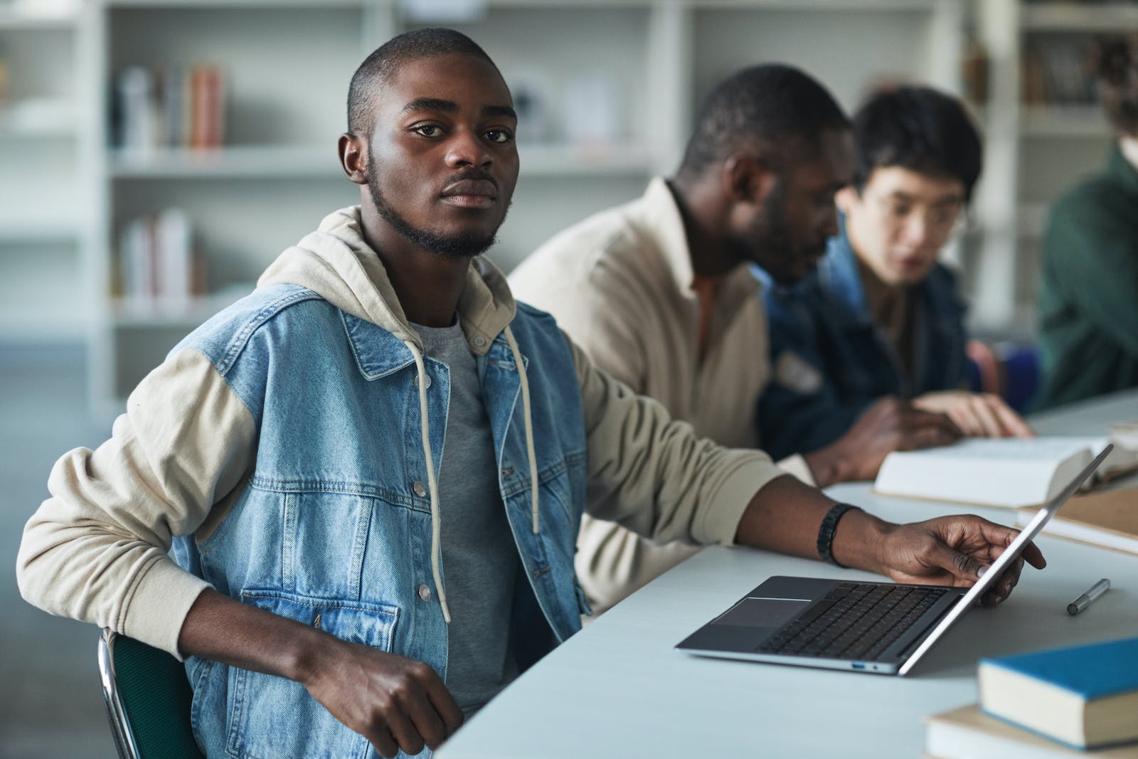 Student with laptop facing the camera