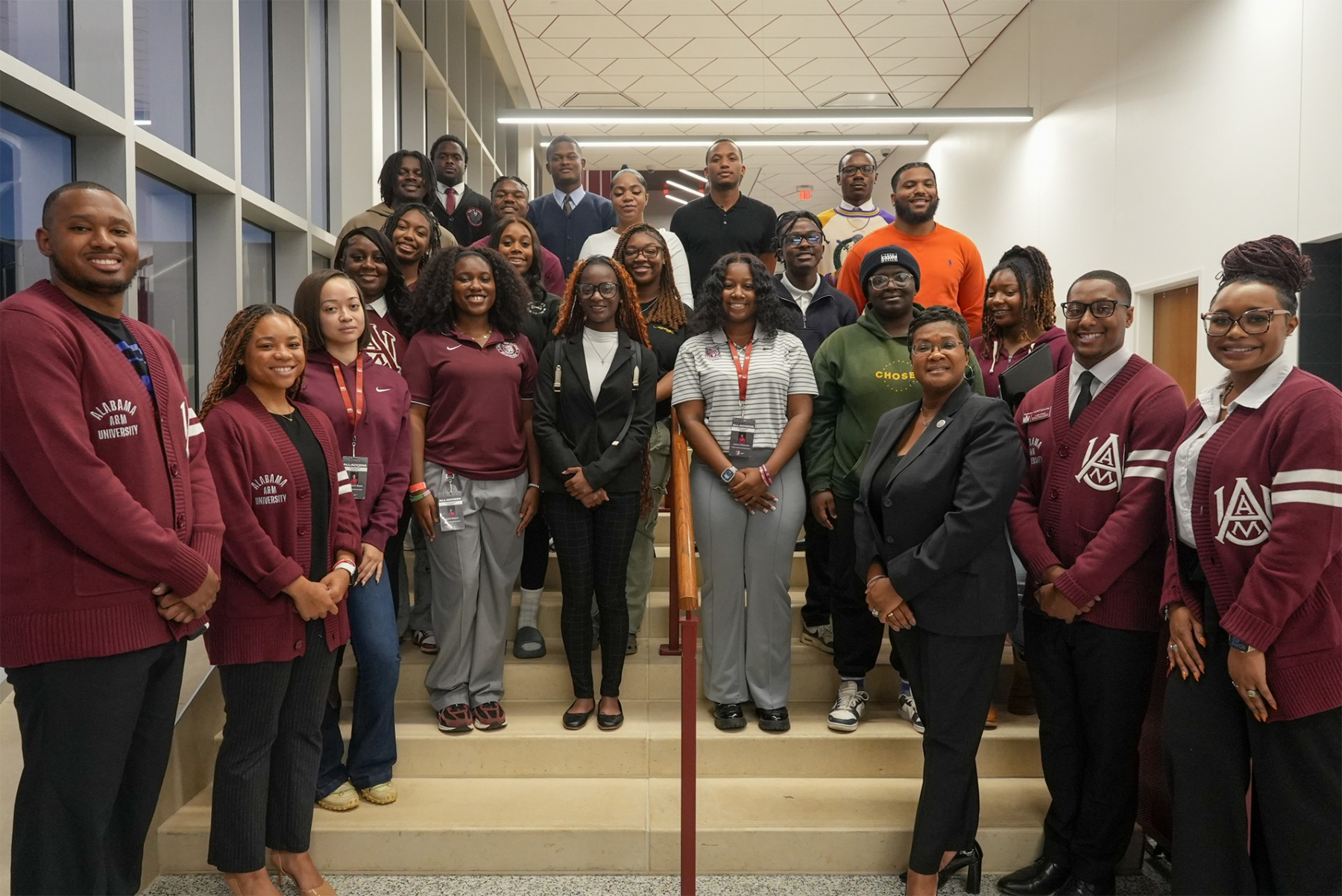 AAMU alumni pose with students attending the NBA HBCU Fellowship Panel Discussion in the AAMU Event Center