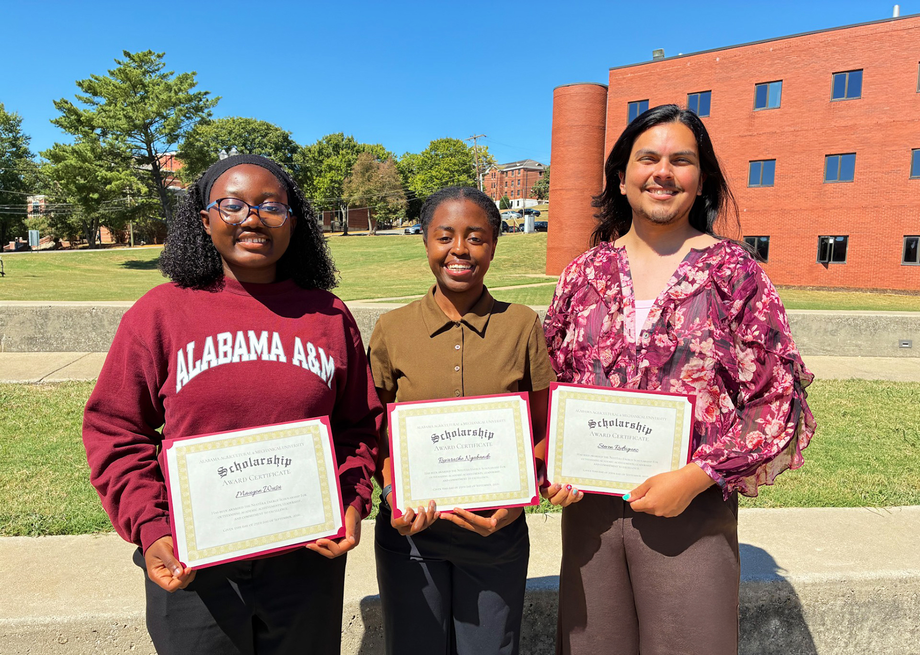 From left, AAMU students Mauyon Wusu, Ruvarashe Nyabanda and Stephen Rodriguez display certificates recognizing them as the inaugural recipients of the AAMU NextEra Energy Scholarship.
