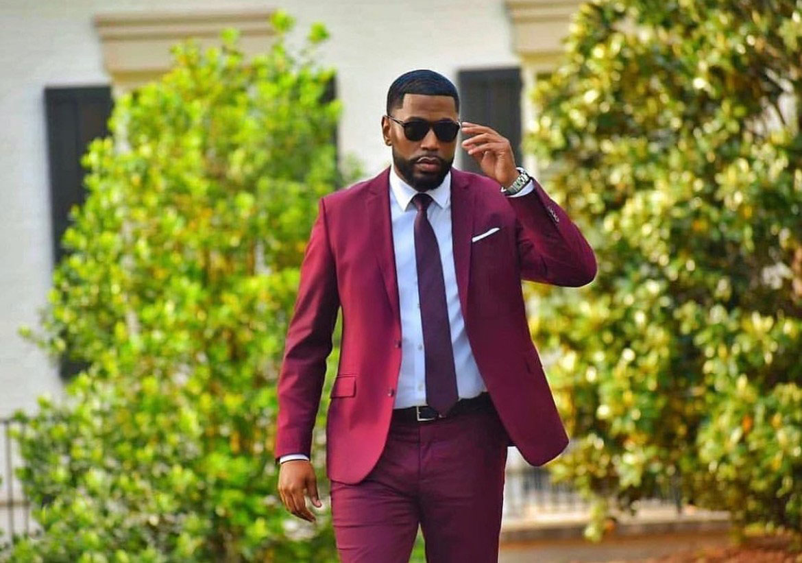 Man wearing sunglasses and maroon suit from Oxford Street Menswear