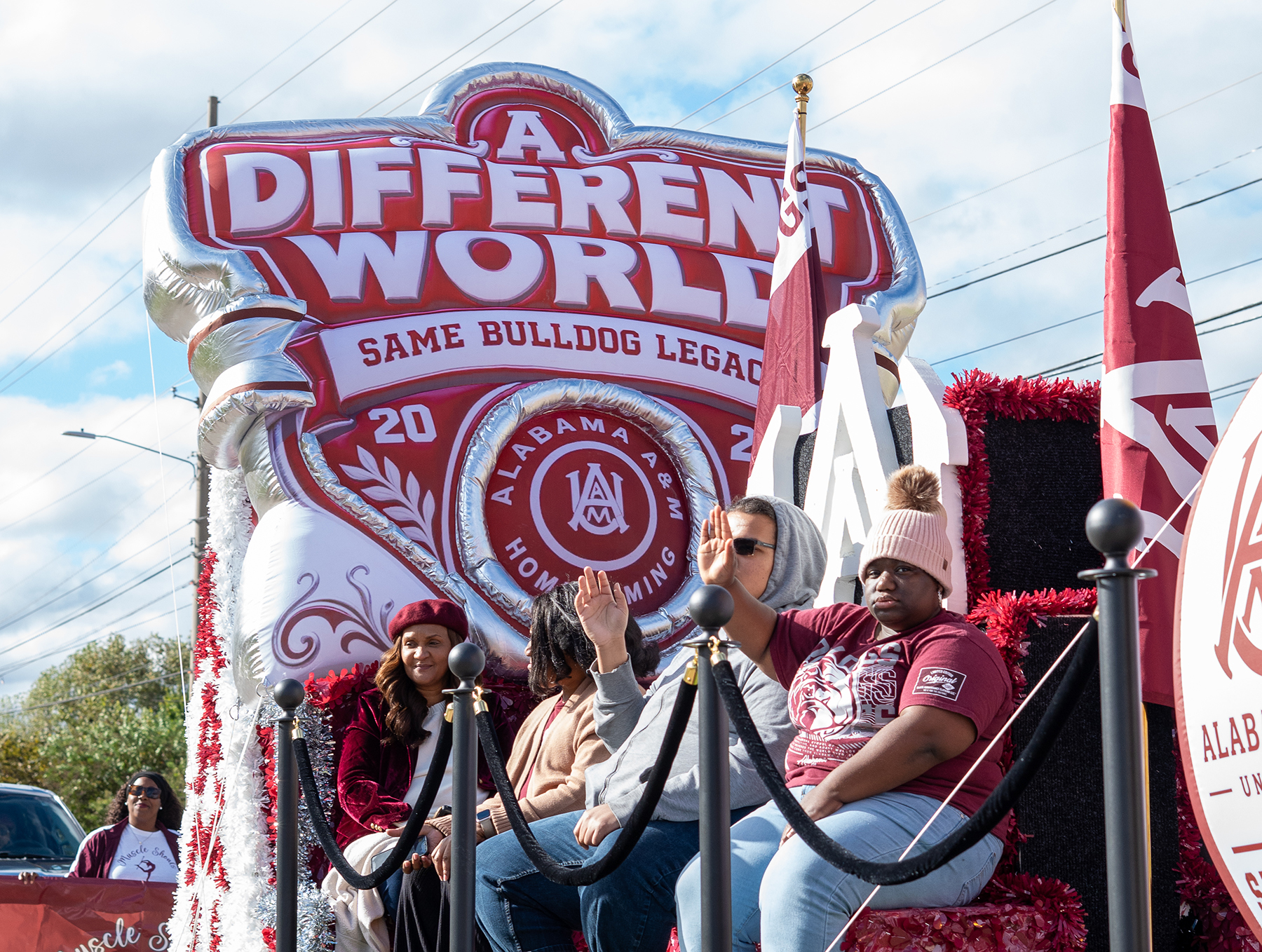 AAMU students ride a decorated float celebrating the 2026 Homecoming theme, “A Different World, Same Bulldog Legacy,” during the parade along Meridian Street.