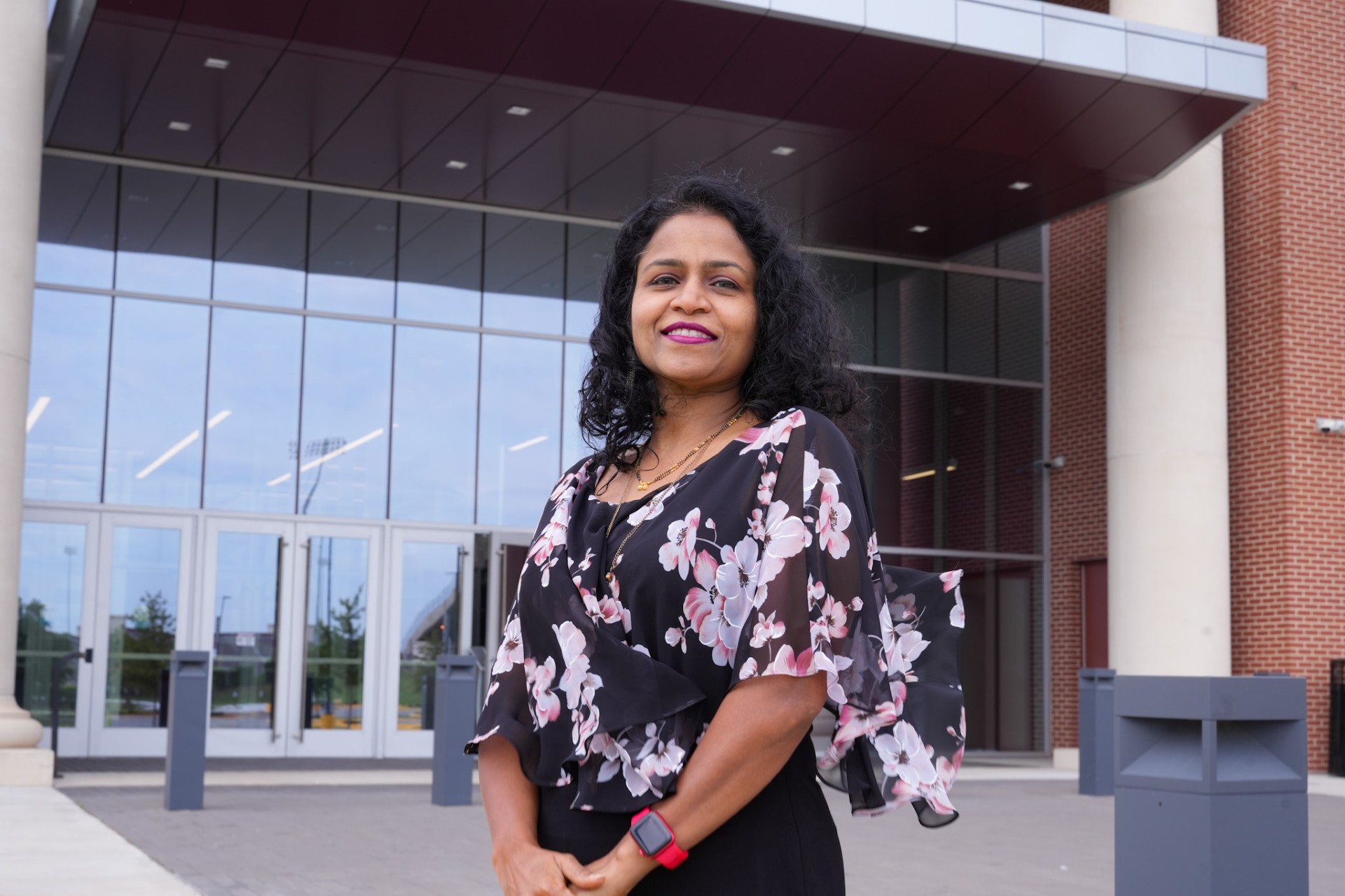 Dr. Padmaja Guggilla smiles in front of the AAMU Event Center