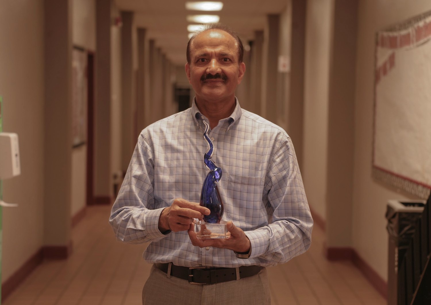 Dr. Raziq Yaqub holds his Joseph Moquin Award