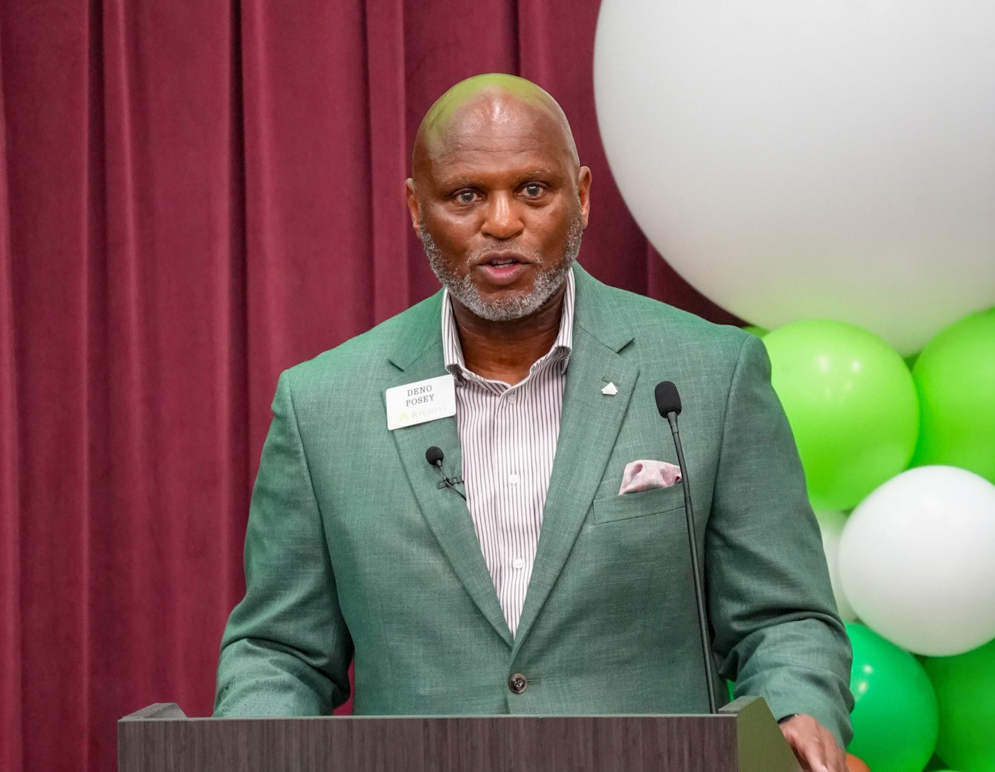 Deno Posey, executive vice president for technology, operations, digital and data at Regions Bank at podium speaking to AAMU students