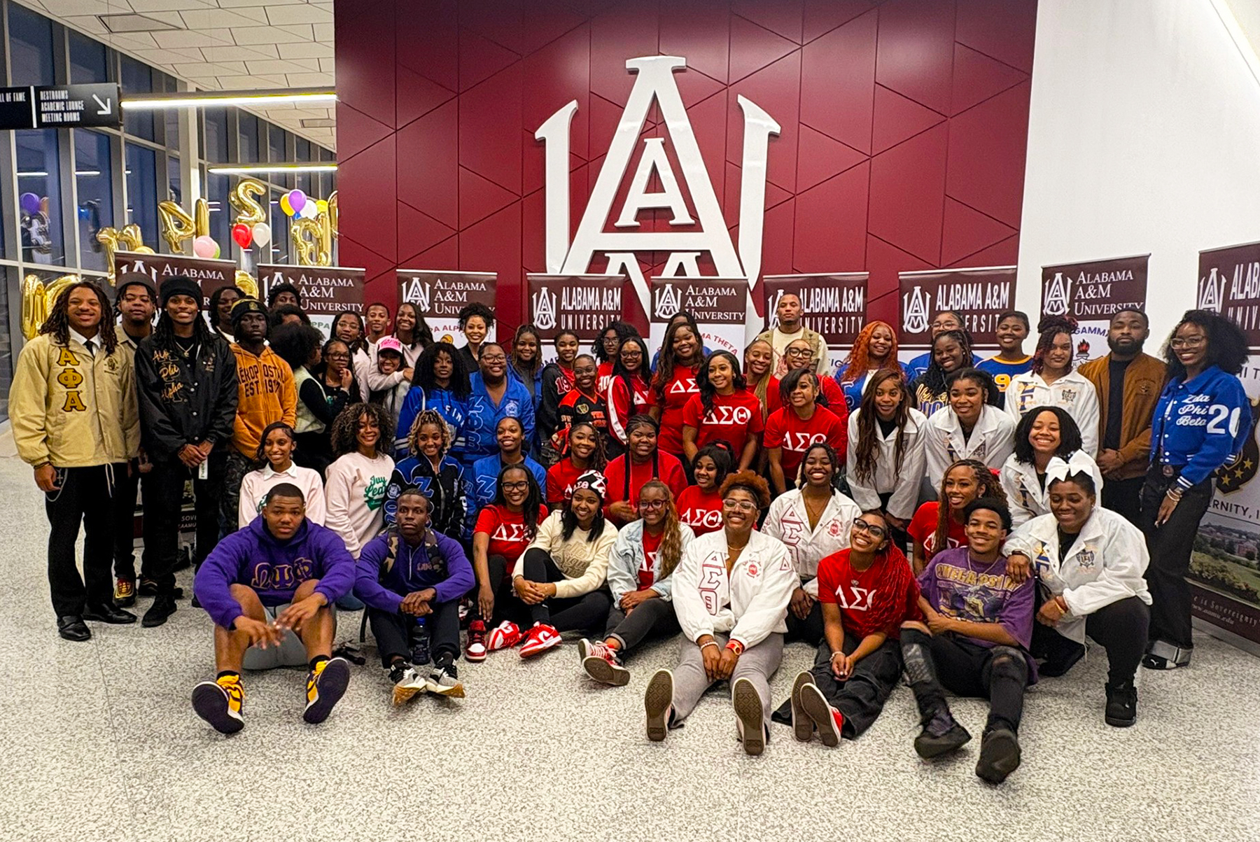 Large group of AAMU NPHC members in lobby of AAMU Event Center