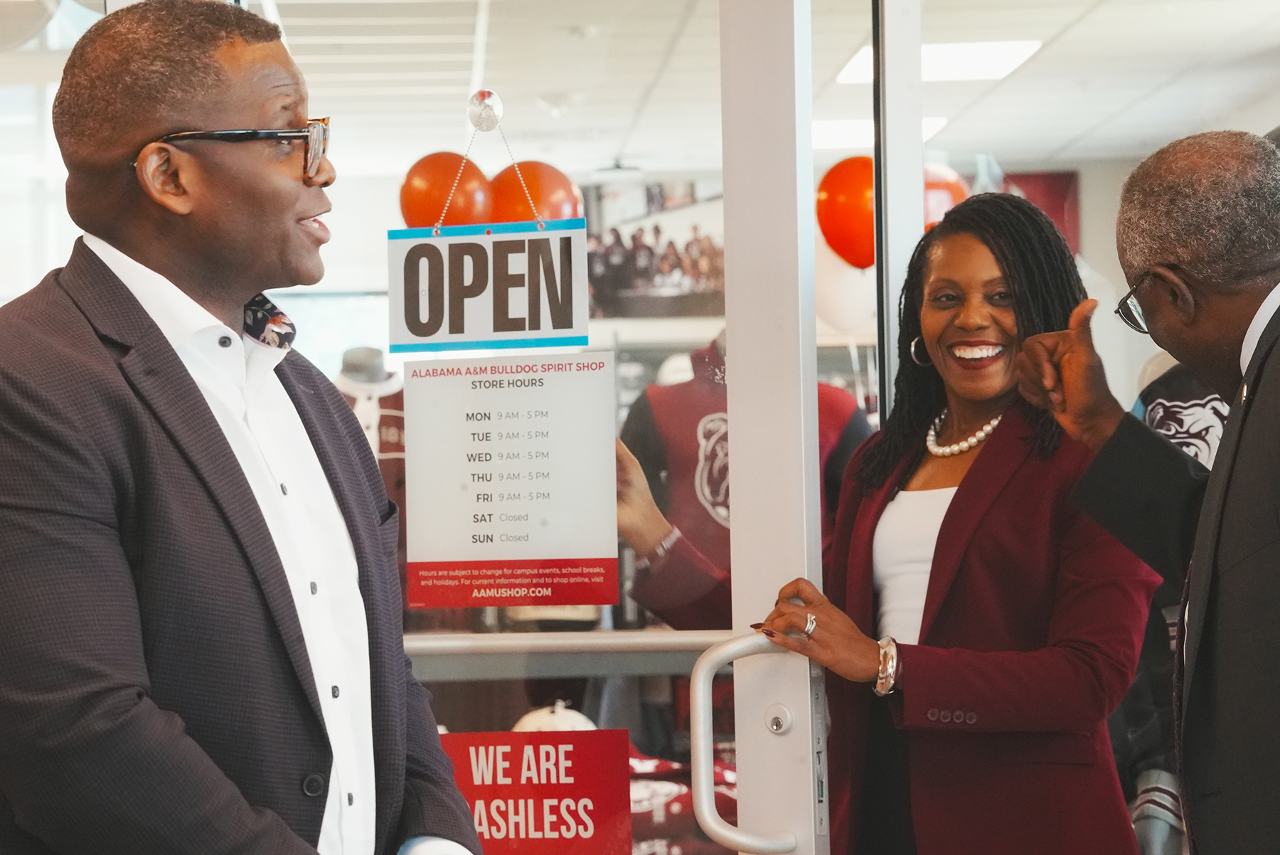 From left, Carlton Spellman, Alabama A&M University Trustee Dr. Scherrie Pickett and Provost and Vice President for Academic Affairs Dr. John Jones celebrate the official ribbon-cutting of the Bulldog Spirit Shop on Tuesday, Oct. 20, 2026.