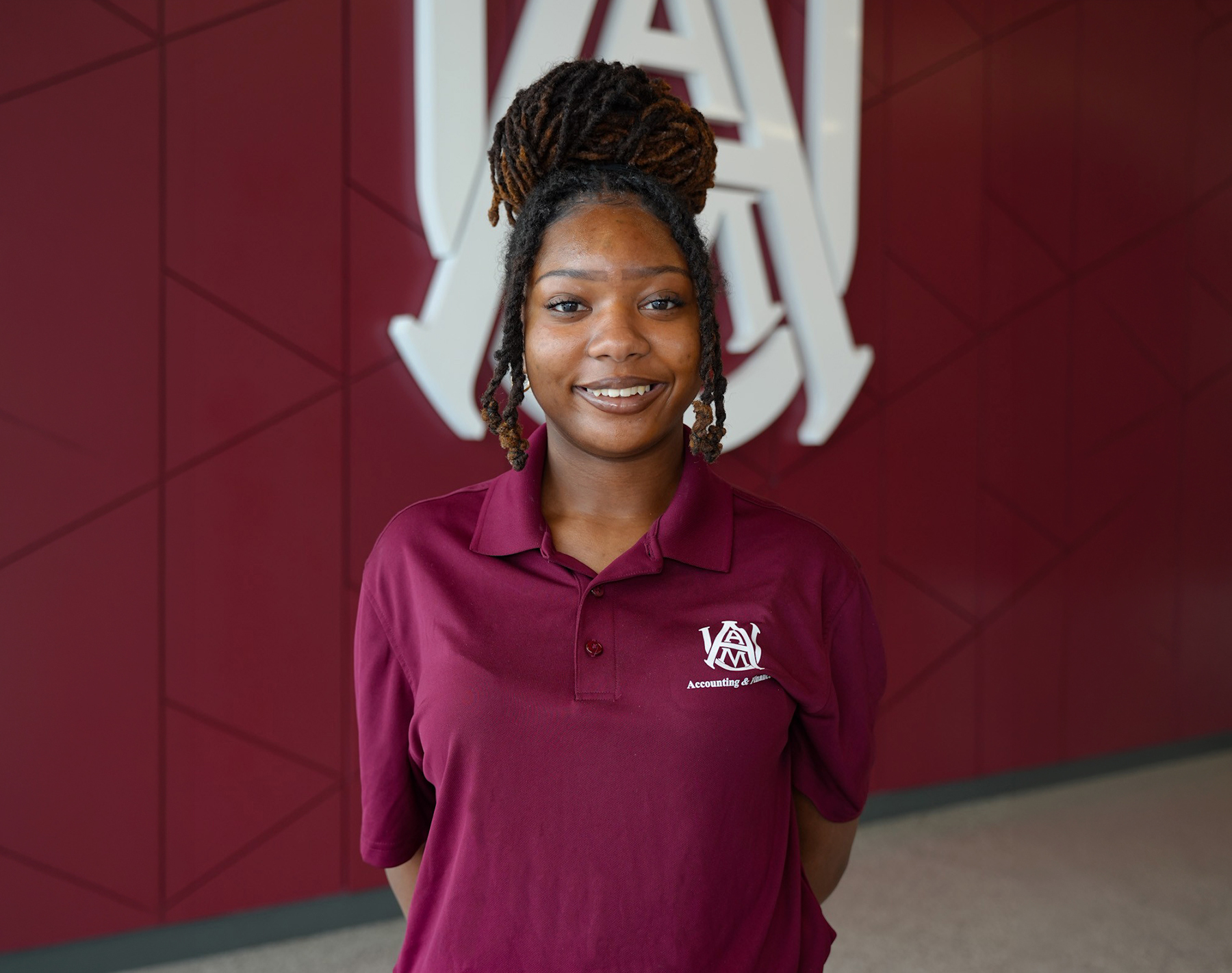 Schylar Roberston smiles inside the AAMU Event Center lobby